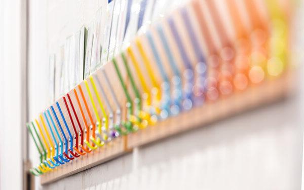 Colourful coat hooks on a wall at a school